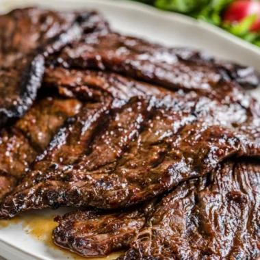 Grilled flank steak with citrus marinade on a barbecue grill