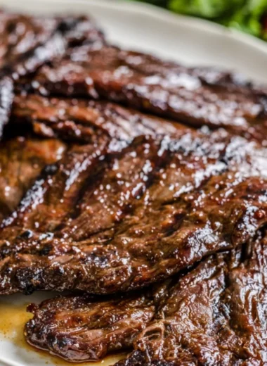 Grilled flank steak with citrus marinade on a barbecue grill