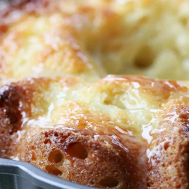 Delicious Lemon Bundt Cake with a bright icing glaze on a rustic table