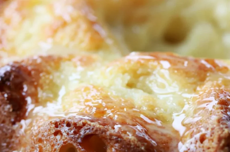 Delicious Lemon Bundt Cake with a bright icing glaze on a rustic table