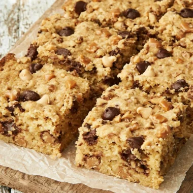 Delicious loaded chocolate chip cookie bars with gooey chocolate and a golden crust