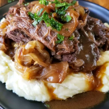 Melt in your mouth pot roast served with vegetables in a rustic dish.