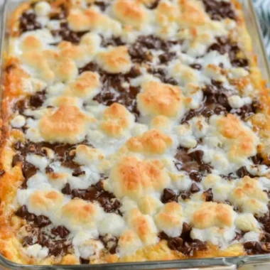 Delicious s'mores magic bars loaded with chocolate, marshmallows, and graham crackers.