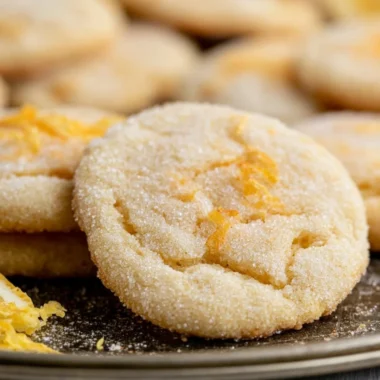Soft and chewy lemon cookies with a bright yellow color and powdered sugar on top