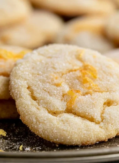 Soft and chewy lemon cookies with a bright yellow color and powdered sugar on top