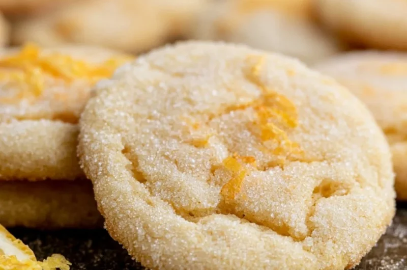 Soft and chewy lemon cookies with a bright yellow color and powdered sugar on top