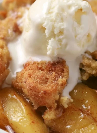Homemade apple cobbler topped with golden crust and served in a baking dish