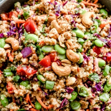 A delicious bowl of Thai quinoa salad with fresh vegetables and herbs.