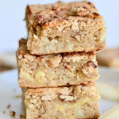 Delicious cozy apple brownies topped with cinnamon and walnuts.