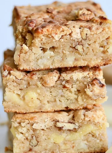 Delicious cozy apple brownies topped with cinnamon and walnuts.