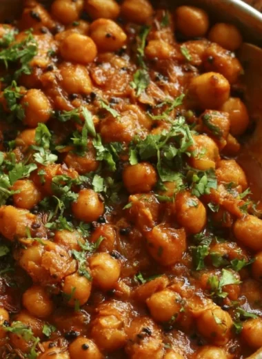 Delicious bowl of chickpea masala garnished with fresh herbs and spices