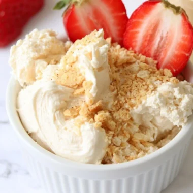Cozy high protein cheesecake dip served in a bowl with fresh fruit