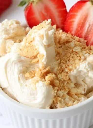 Cozy high protein cheesecake dip served in a bowl with fresh fruit