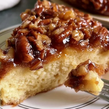 Upside Down Caramel Pecan Cake topped with pecans and rich caramel sauce