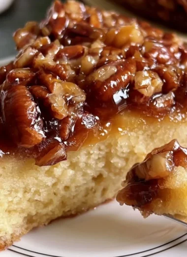 Upside Down Caramel Pecan Cake topped with pecans and rich caramel sauce